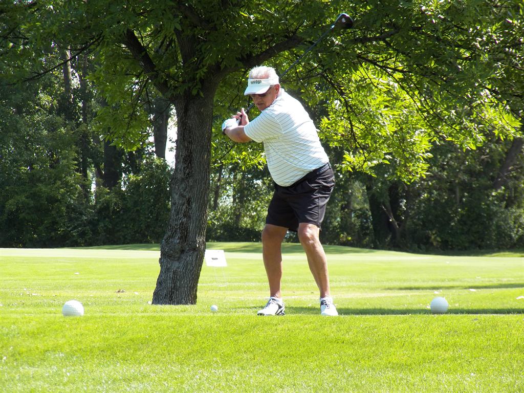Richard Stevens starts to unload on his tee shot on #13 on his way to victory in the 65-69 age group.